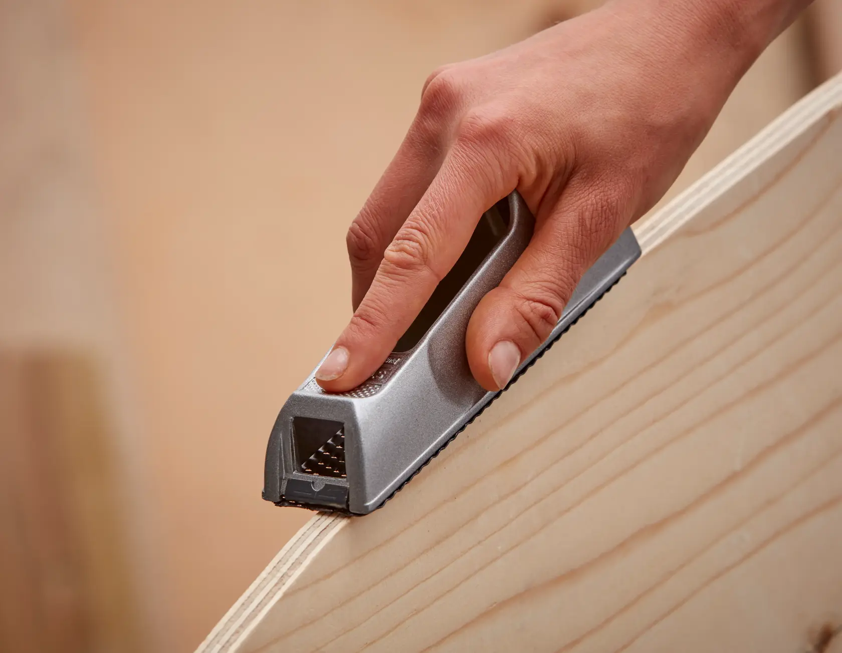 STANLEY 5-21-399 tool in hand smoothing wood surface, close-up photography.