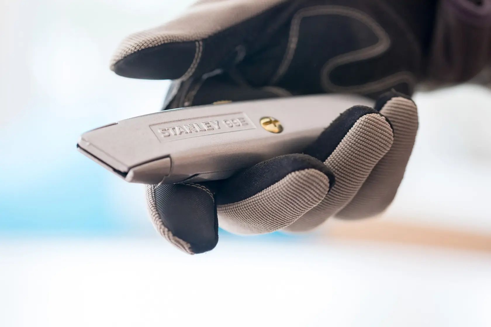 Photo of STANLEY 1-10-099 utility knife held in a gloved hand.