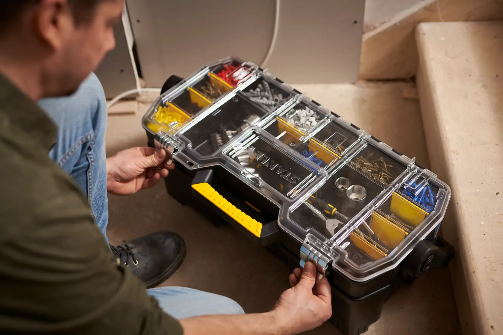 STANLEY 1-97-514 organizer box with clear lid, yellow handle, compartments with hardware, used on site.