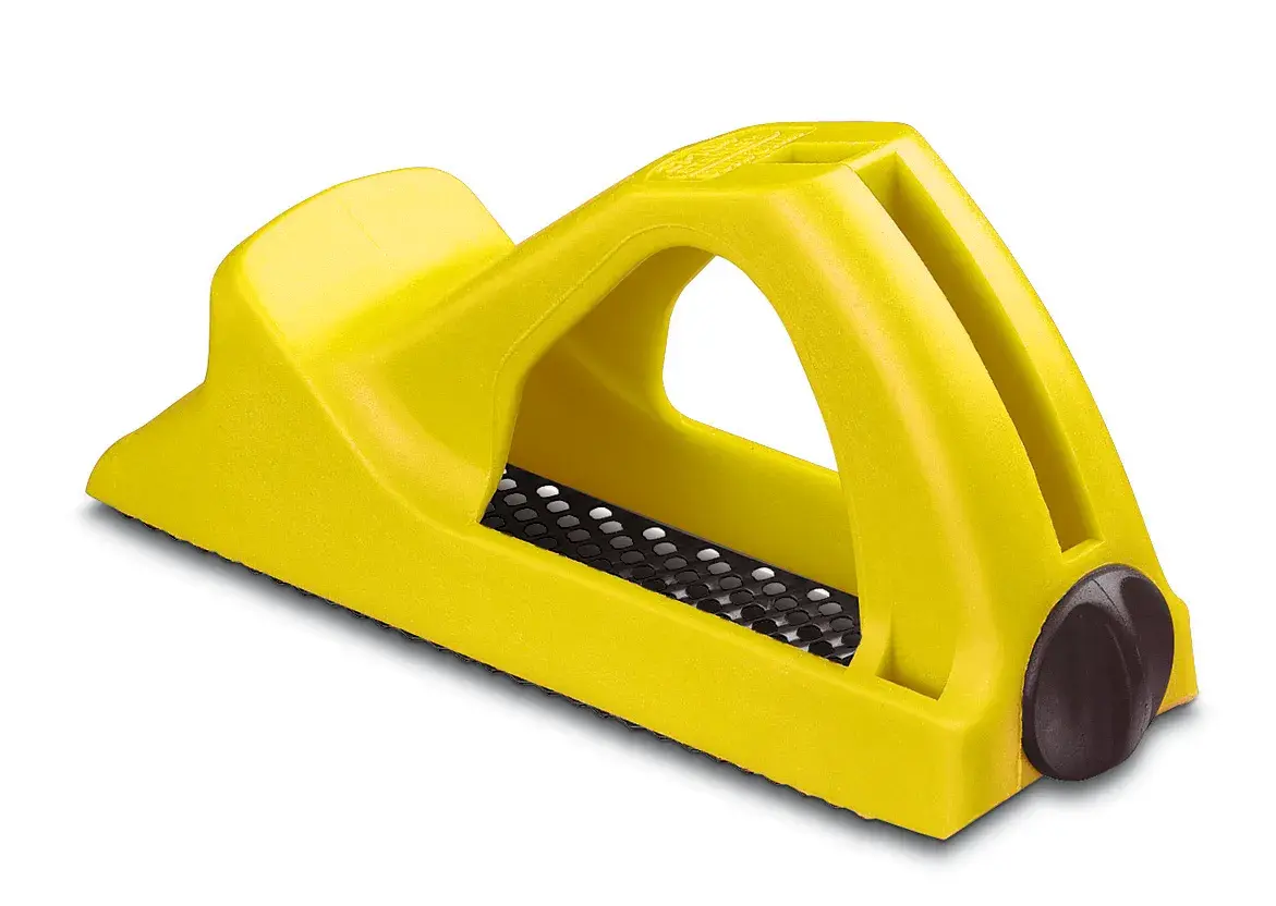 STANLEY 5-21-104 yellow plastic hand rasp, side angle, textured metal blade visible, photography product.