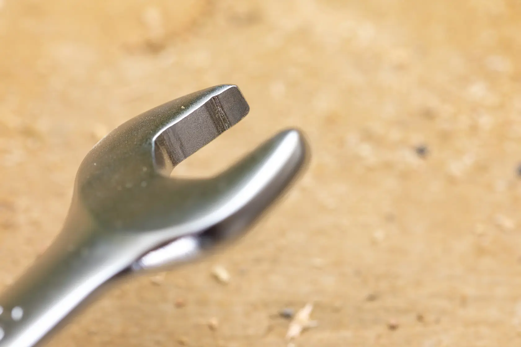 STANLEY FMMT13085-0 wrench close-up on wooden surface, silver finish, open-end view.