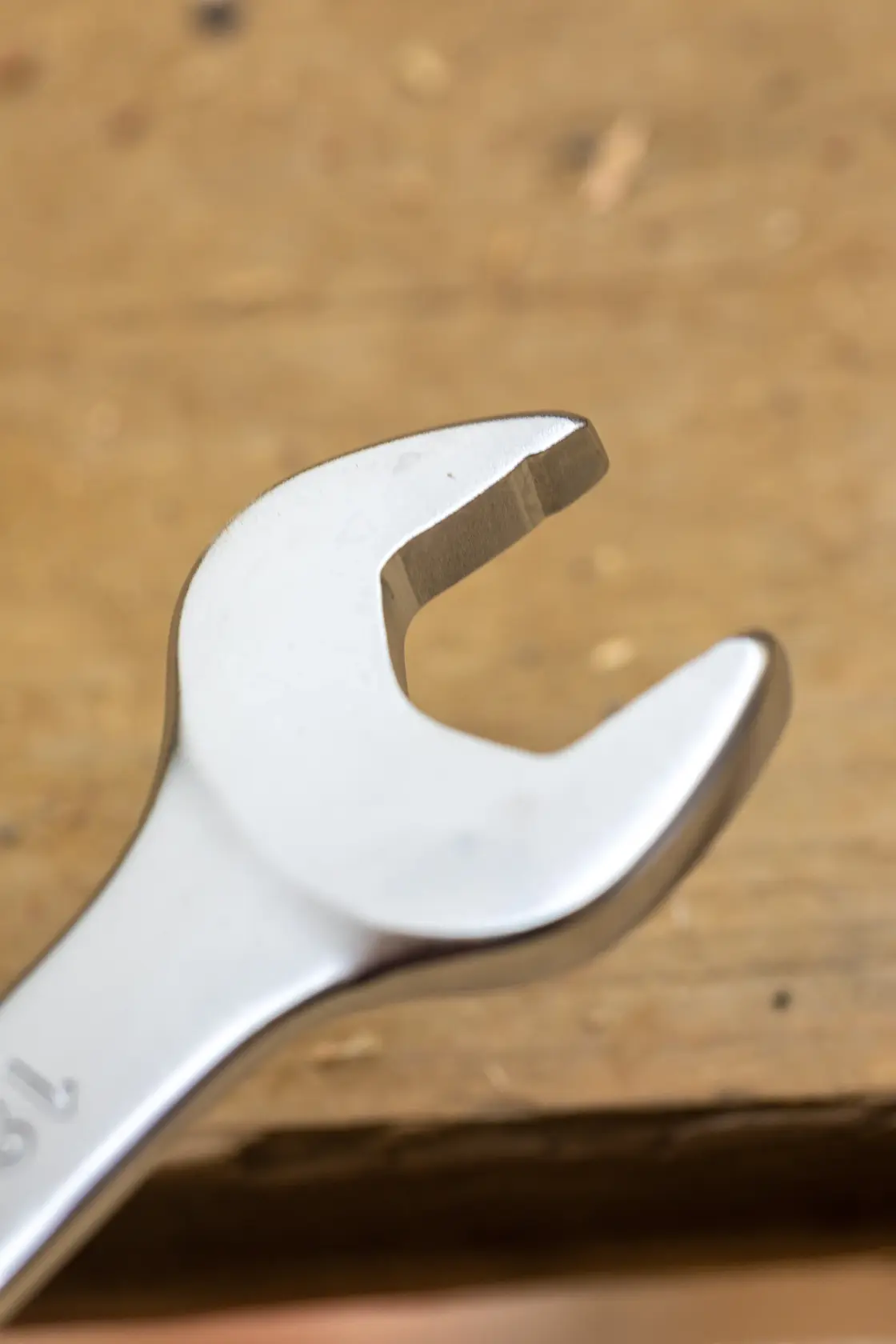 STANLEY FMMT13086-0 open-end wrench, close-up on metallic tool over wood surface, photography category