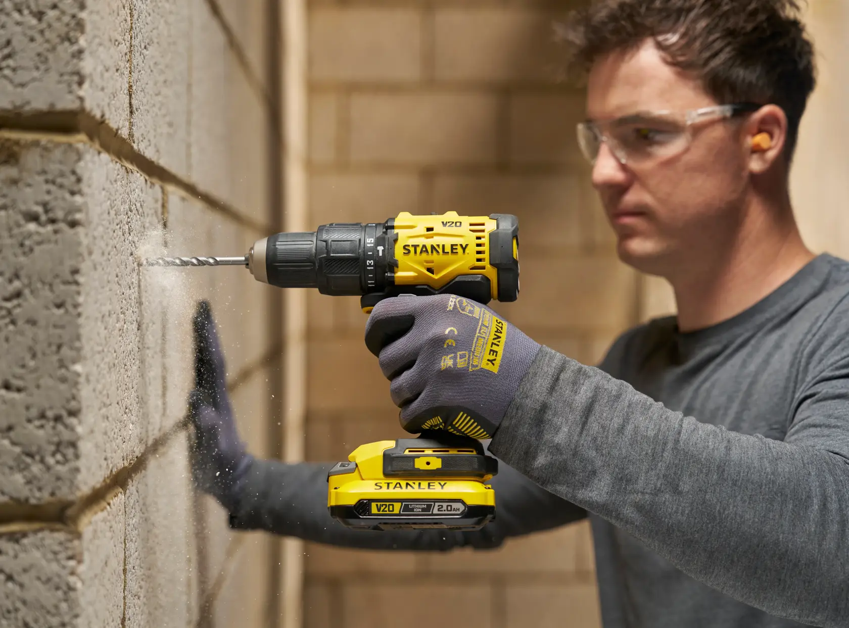 Stanley drill in use on wall. Photography. SKUs: STA56040, STA56040-QZ.
