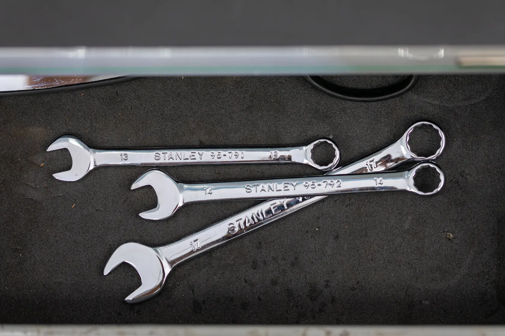 STANLEY STMT95909-0 combination wrenches in silver, top view, placed inside a tool drawer.